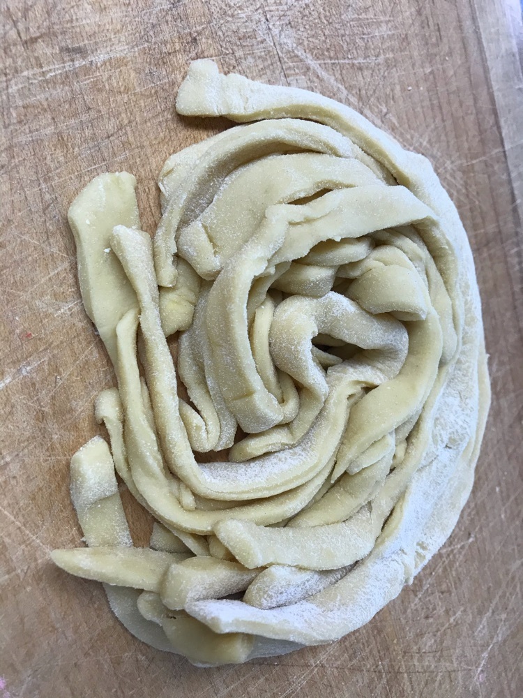 A nest of thick pasta noodles ready to be cooked