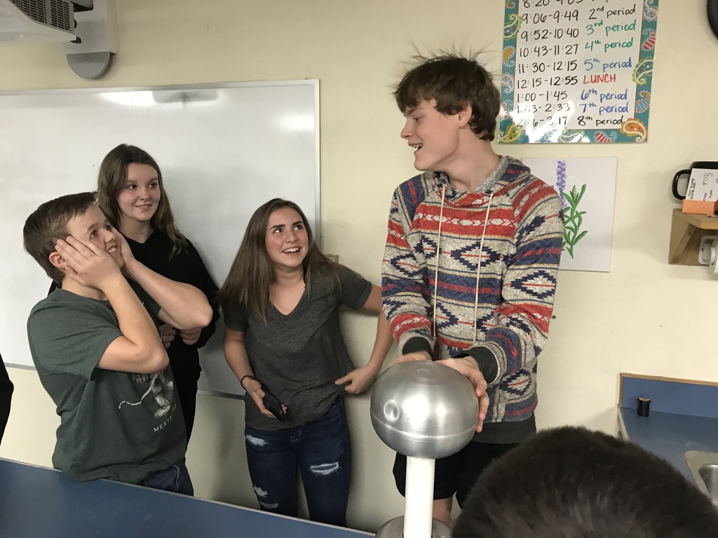 8th grade students learn about static electricity with the Van set Graaf generator.